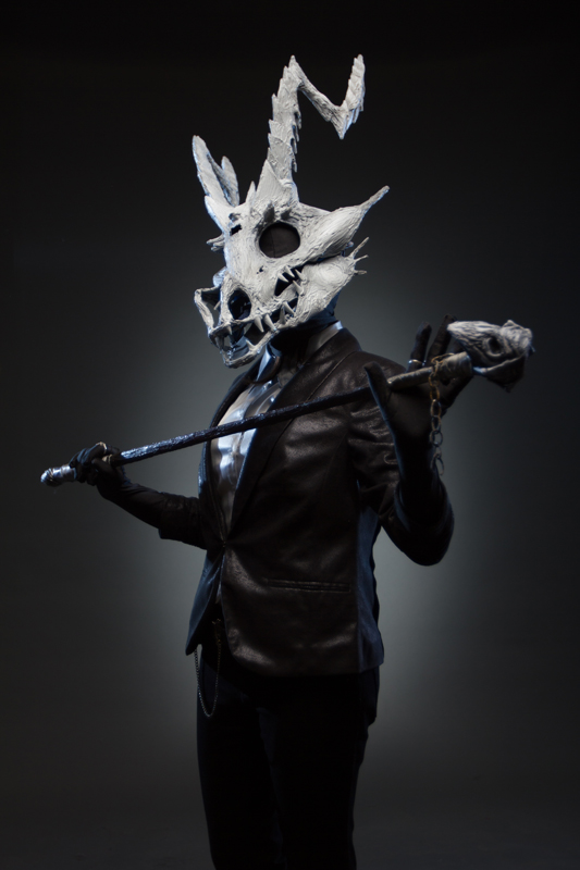 Skull headed demon cosplay with suit and chain