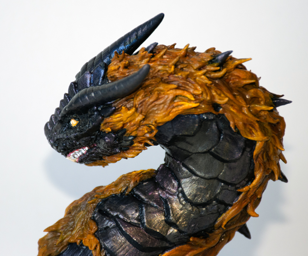 bust of a black dragon with a yellow mane