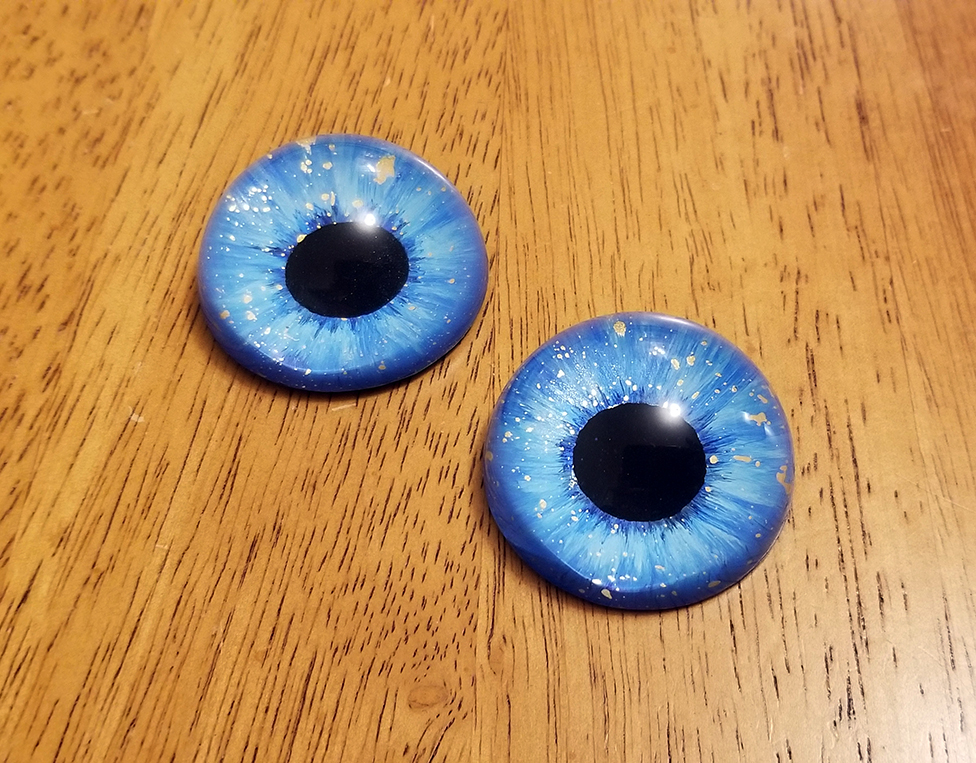 Round pupils with a pearlescent blue iris and gold flecks